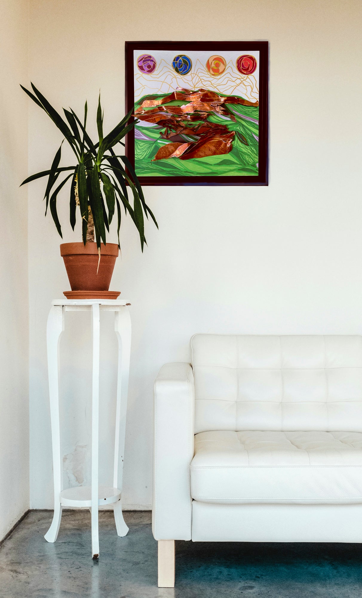 In situ image of the piece hanging on a white wall over a modern-style couch. A potted plant sits on a high stand just below the painting. 