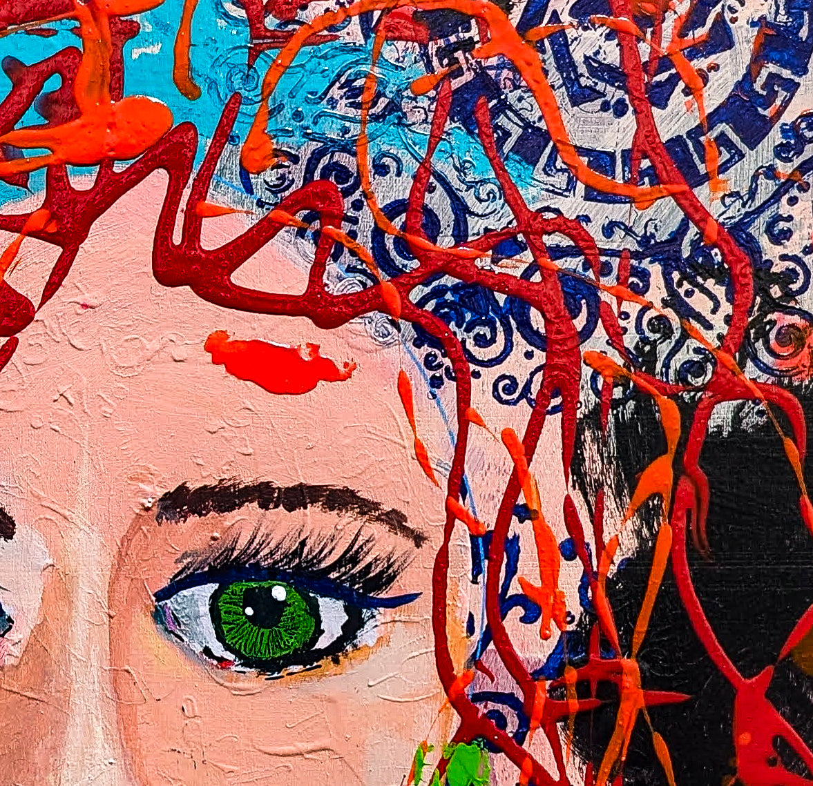 A close up look at Wistful's locks, red squiggles of paint on top of mixed media stencils in shades of blue.