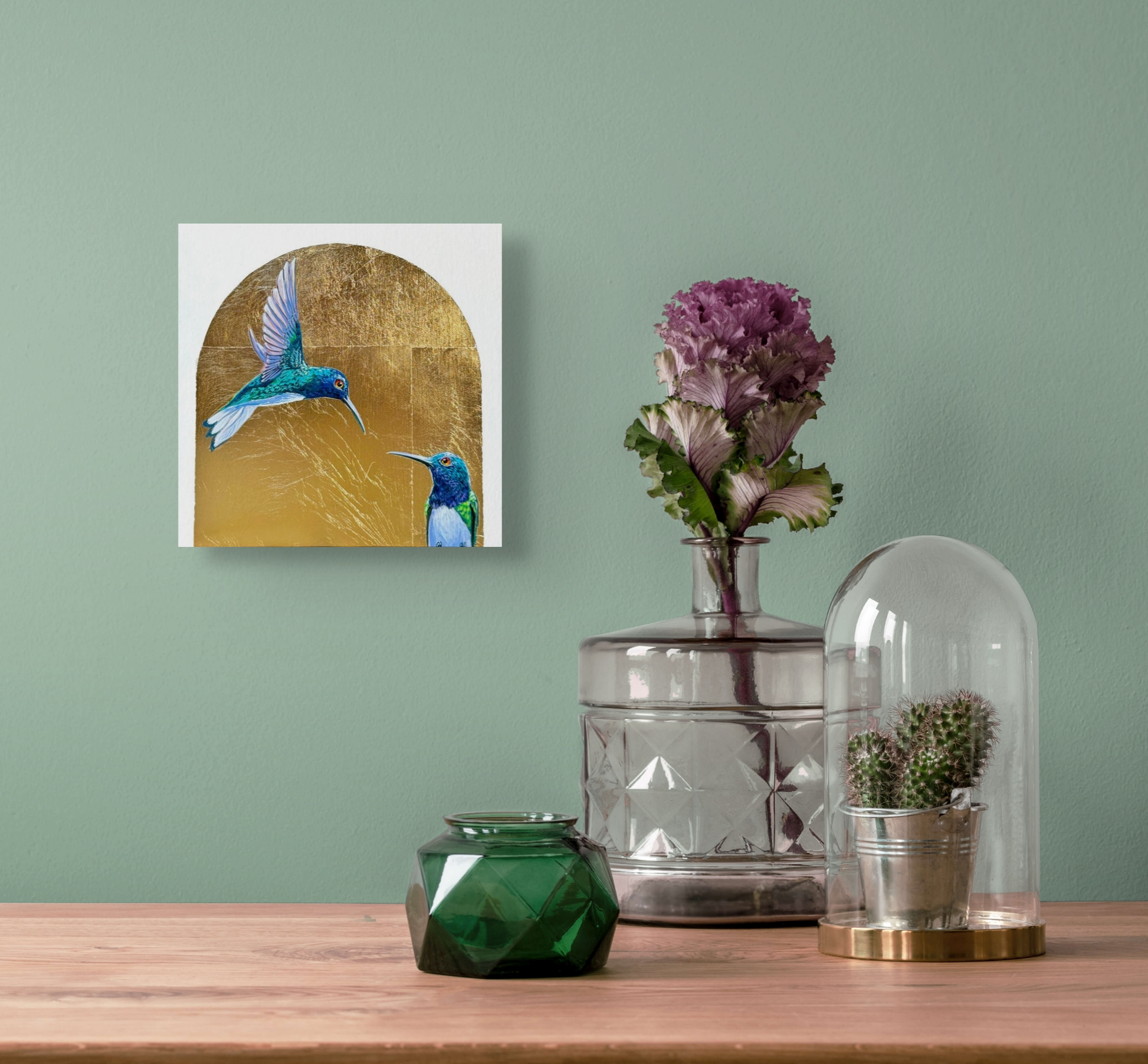 Crossing Swords hangs on a mint green wall next to a vase with a purple flower sitting on a small table.