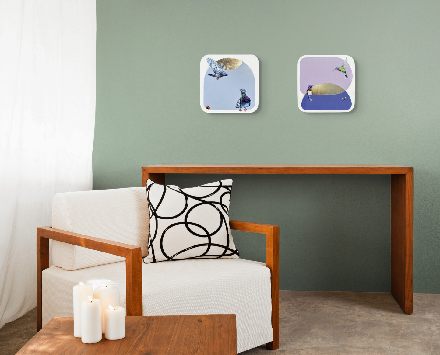 Hum and A Buzz and Flying In are shown here hung as a set on a green wall above a set of modern style furniture