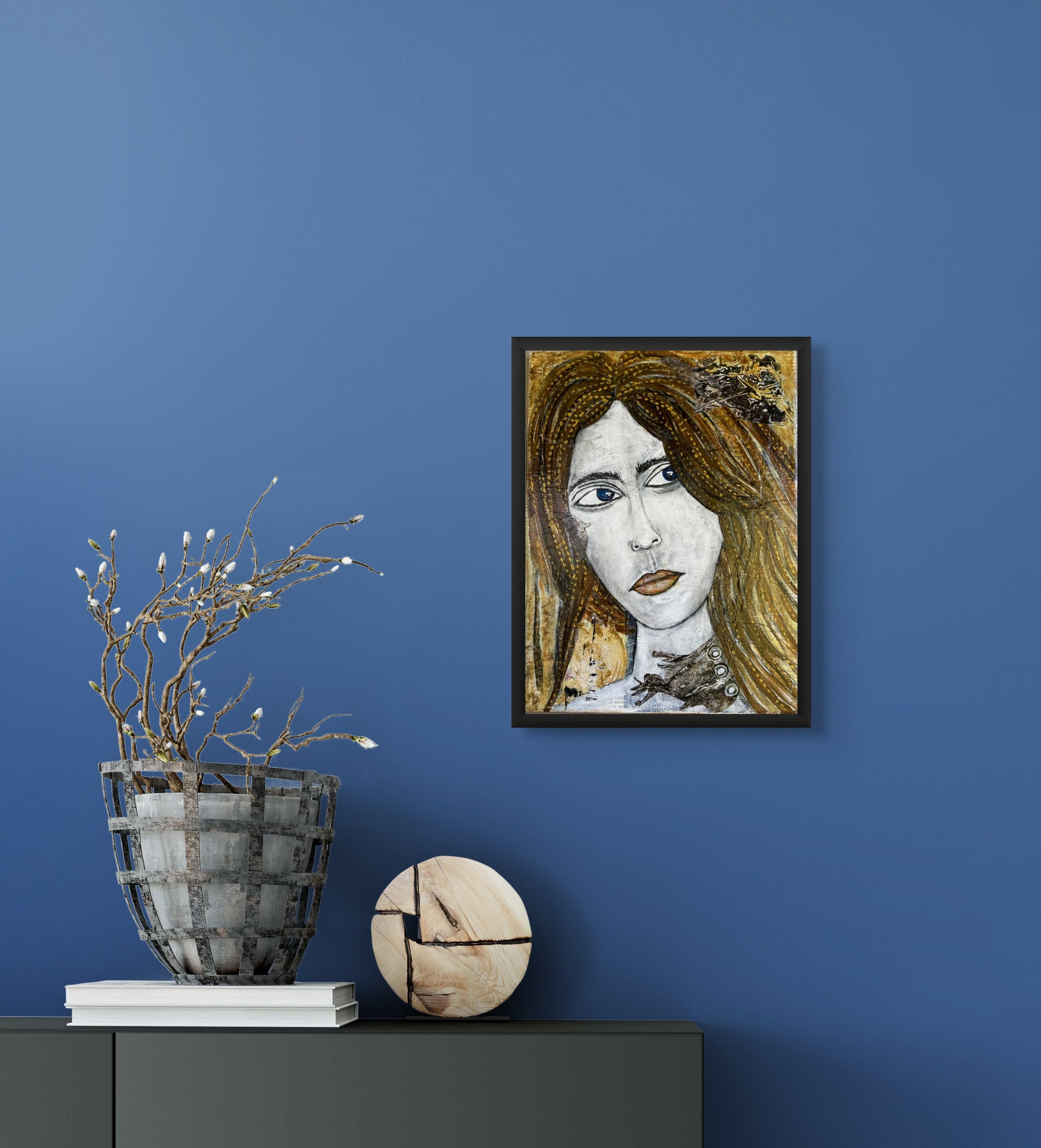 This image shows My Neck Tie hanging on a blue wall just above a desk with dried flowers and a decorative piece of wood.