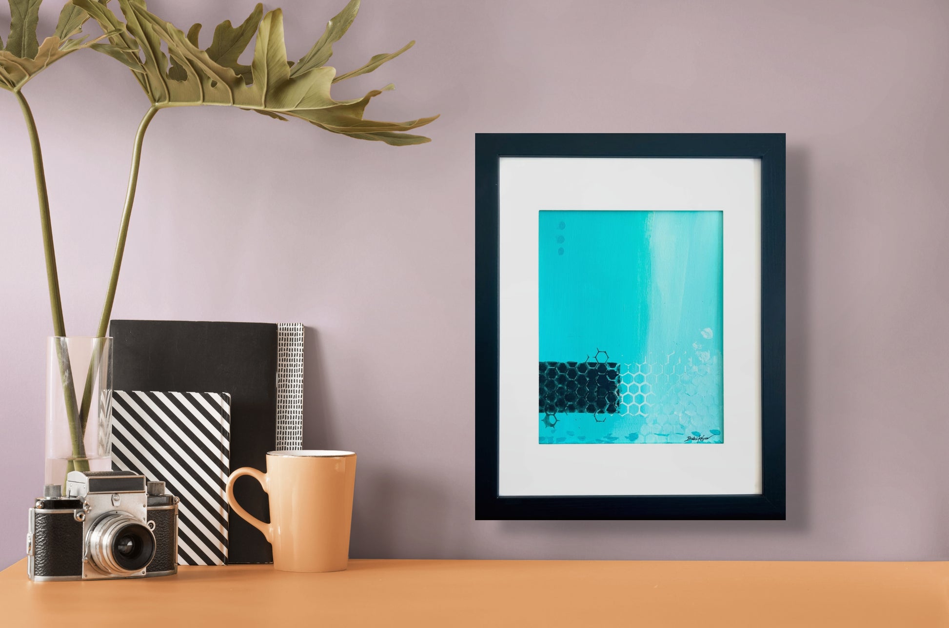 Striking acrylic painting with turquoise background embellished with blocks of black and stenciled white; artist Bob Hogue; shown in a black wooden frame with white mat; in situ