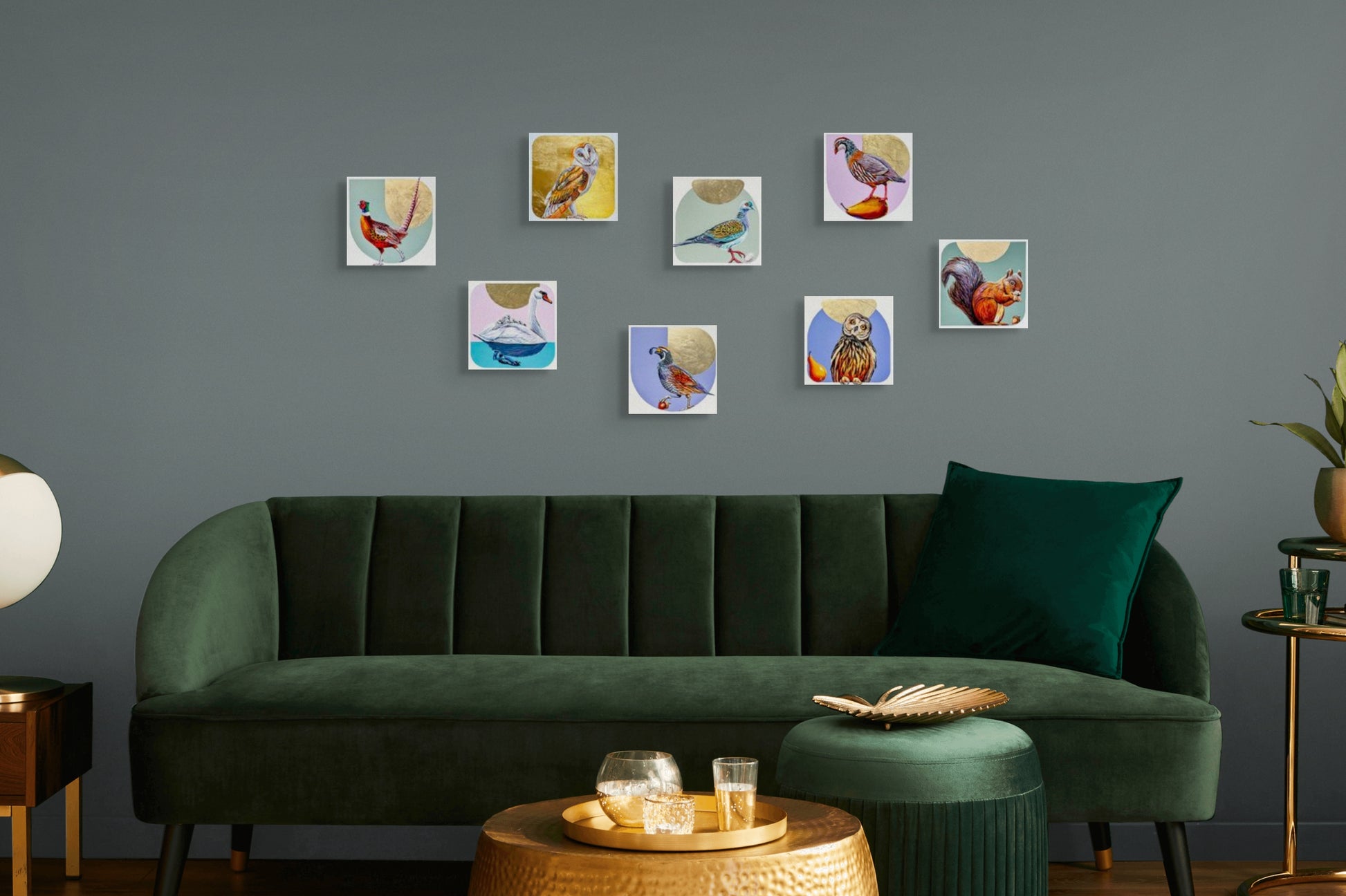 image shows an in situ view of eight of Marie Lavallee's mini-panel paintings including Head Tilt hanging over a dark green velvet couch.