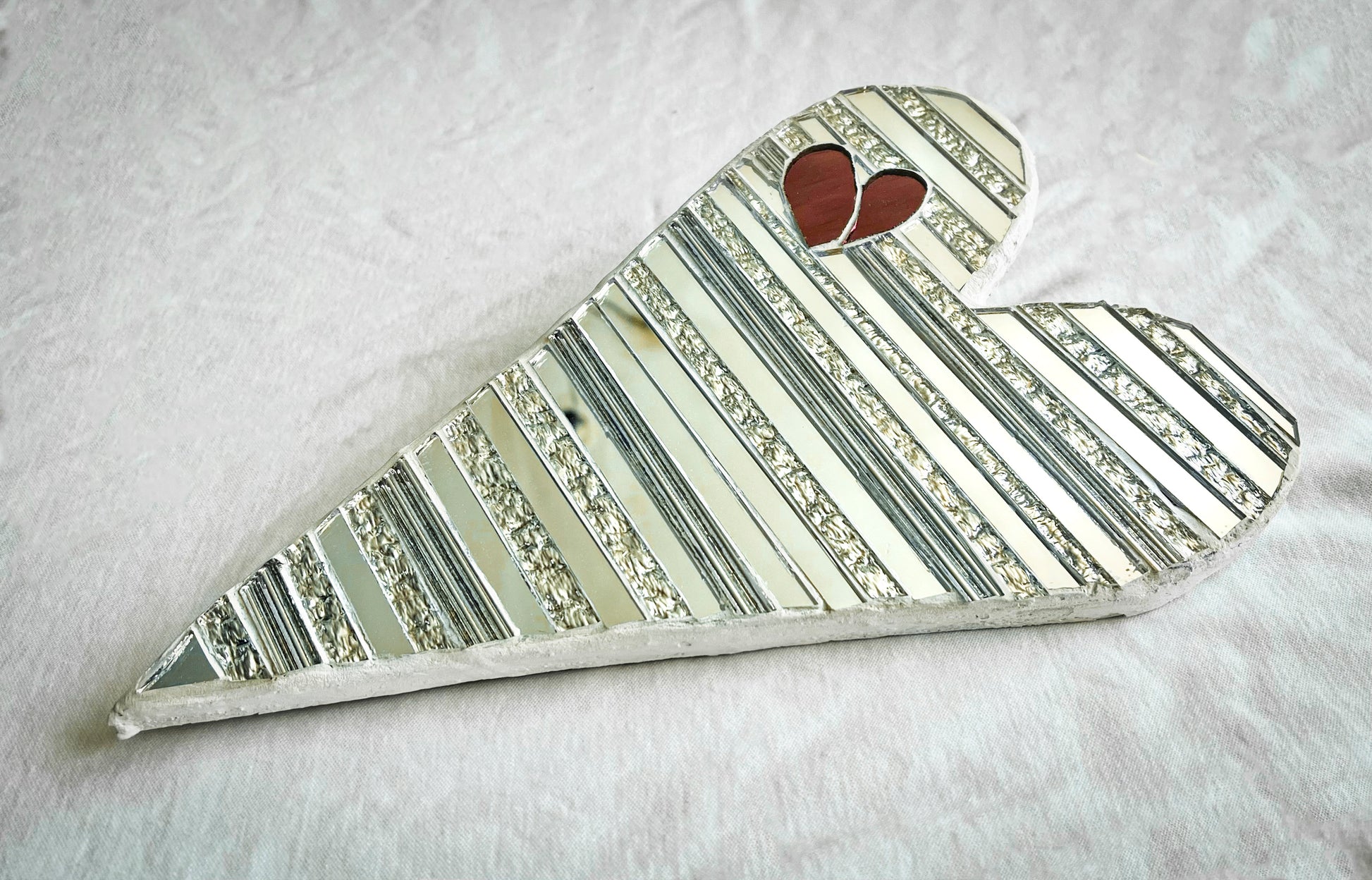 Heart-shaped mosaic made of mirrored-glass pieces with red mirror heart shape inside by Denise Marshall - title 'Hearts to You!'